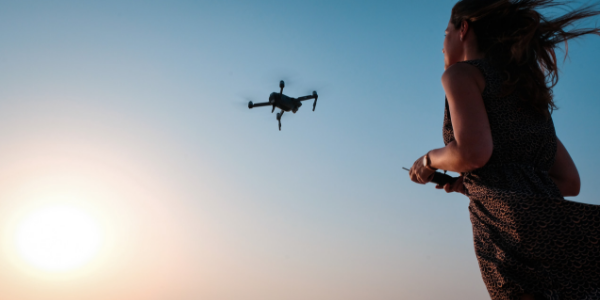 Image of Woman Flying Drone from Best Travel Drones Image 5